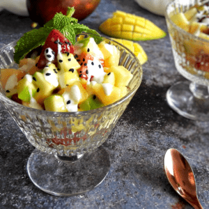 Mango fruit salad with yogurt drizzled over