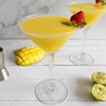 Mango daiquiris in martini glasses on a counter