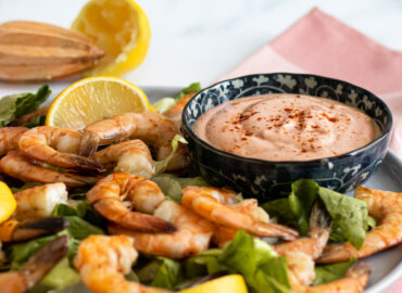 Marie Rose sauce on a plate of prawns and lemon