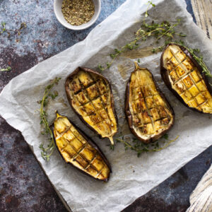 Roasted Aubergines on a baking tray with thyme