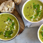 Pea and mint soup in bowls with bread