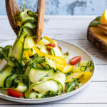 Courgette Salad being picked up by wooden servers