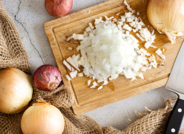 Onions around a board of diced onion