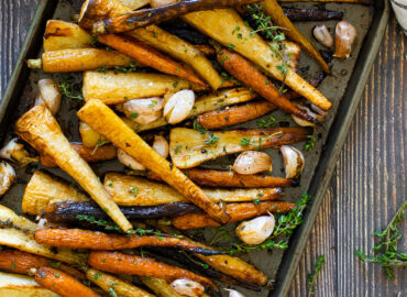 Carrots and parsnips roasted on a tray with honey
